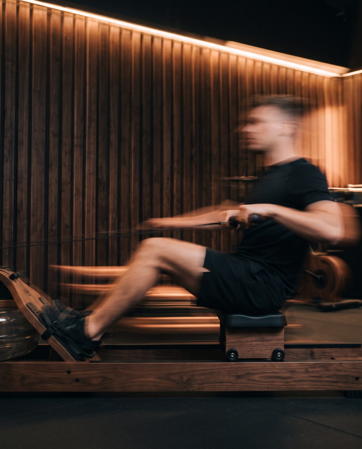 Athlete rowing on the walnut rower